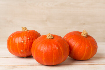 Orange pumpkins with autumn decor on table