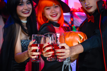 Asian Teenagers Drinking and Cheers in Halloween Costumes, Celebrate The Enchanting Halloween Season. Celebrating Halloween Haunt Party of Asian Style, Fusion of Tradition and Frightful Delights.