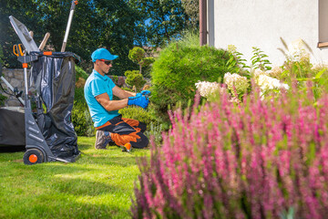 Pro Gardener Worker Taking Care of the Backyard Garden