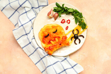 Plate with tasty Halloween mini pizza on pink background