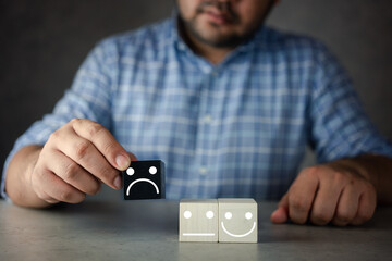 The customer hand picked and choosed a sad face icon on the black wood cube. Customer review...