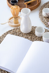 Book mockup design. Blank white book on dining table in asian style with tableware