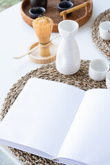 Book mockup design. Blank white book on dining table in asian style with tableware