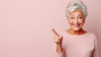 Senior beautiful woman pointing aside and smiling with pink background and copy space - obrazy, fototapety, plakaty