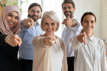 Obraz premium Mature and young staff point finger at camera choosing you. Recruiting agency hr managers give opportunity employment in international company, makes possible to prove yourself and make career concept
