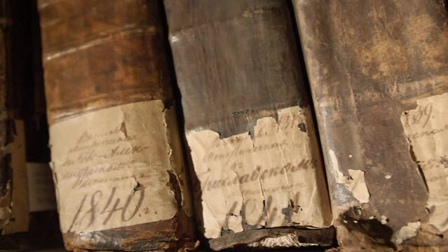 Close up of very old books. Camera moves from left to the right. Vilnius, Lithuania - 05 15 2023.