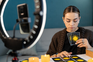 Fortune teller blogger reading fortune lines on screen smartphone, online fortune telling. Psychic...