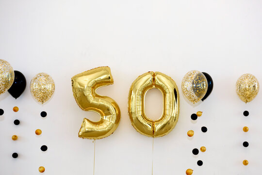 Golden numbers 50 on the wall of the banquet hall. Fifty years anniversary in the design.