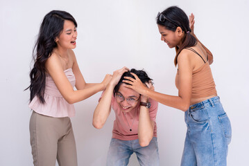 A young asian man getting ganged up on by two furious women insulted by his offensive comments. A...