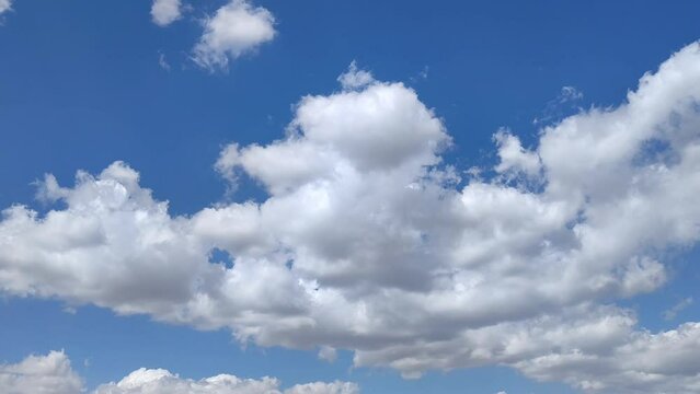 At noon the cumulus clouds move across the sky
