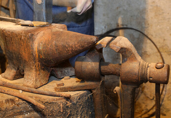 heavy iron anvils inside the bookcase and the hammering of the blacksmith who seems to be moving