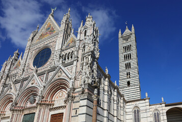 Siena Cathedral in the Tuscany in Italy and the bell tower with the characteristic stripe and dark...
