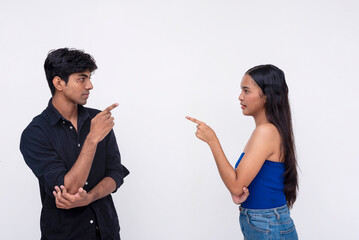 A young multiracial couple upset with each blaming each other for their problems, pointing fingers...