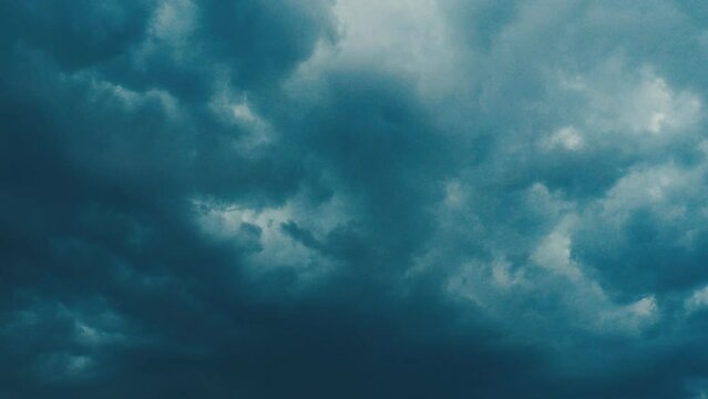Atmospheric circulation is a set of air currents over the earth surface. Gray blue clouds. Puffy fluffy dark clouds. Cumulus cloud cloudscape slow motion. Autumn or winter. Nature weather forecast.