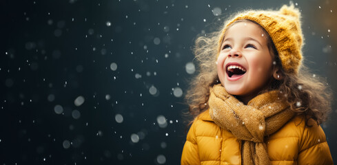A child catching falling snowflakes isolated on a winter gradient background  - obrazy, fototapety, plakaty