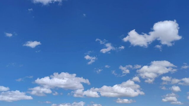 Landscape in the radiant sky with cumulus clouds moving at noon
