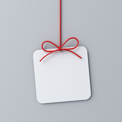 Hanging minimal gift box rounded square sign paper card with red ribbon rope bow isolated on grey background with shadow minimal conceptual 3D rendering - obrazy, fototapety, plakaty