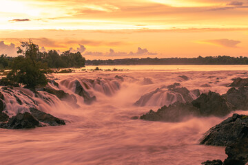 waterfalls in rainforest; beautiful natural wonder combining mountains, and waterfalls slot; river...