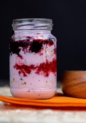 a glass jar with sweet delicious yogurt yams and muesli