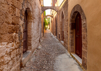 Fototapeta na wymiar Old narrow traditional city street in Rhodes.