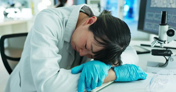 Tired, sleep or scientist exhausted in lab on table with burnout is overworked from research deadline. Lazy, medical or woman with stress, rest or fatigue napping on a break in overtime at desk