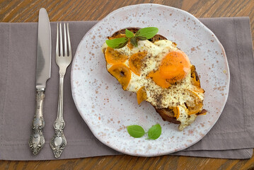 open sandwich with egg and yellow tomato