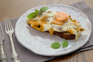 open sandwich with egg and yellow tomato
