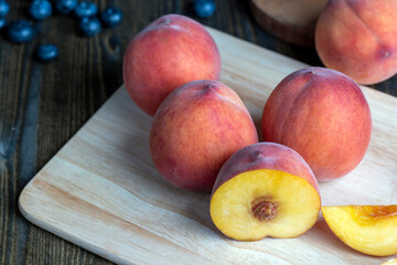 Ripe fresh peaches on a wooden table