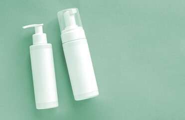 Mock-up of white plastic cosmetics bottles with skincare