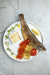grilled fish on a plate in a restaurant