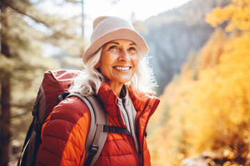 Portrait of mature senior woman hiking in autumn forest , concept of travel lifestyle adventure active vacations outdoor and healthy with fall leaves colors