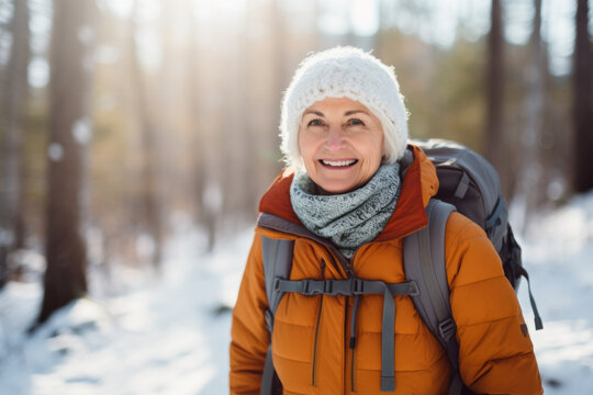 Portrait of mature senior woman hiking in winter snowy forest , concept of travel lifestyle adventure active vacations outdoor and healthy with white snow landscape