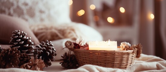 Candlelit cozy home with rustic basket of pine cones and spices