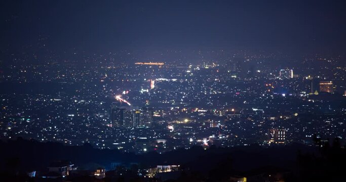 Timelapse of city lights at night, taken from the distance