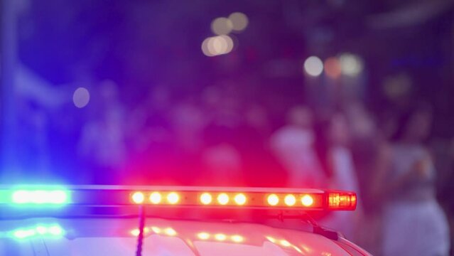 Police car on a city street. Red blue flasher on the police car