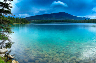 Blue green lake water with mountain backdrop