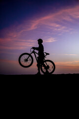 silhouette of a cyclist on sunset