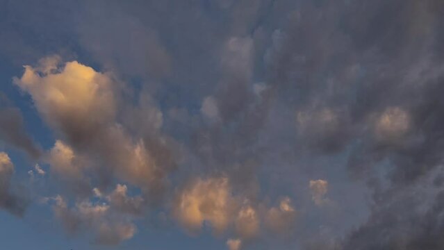 Sunset sky with orange clouds moving