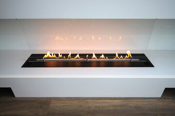 Burning eco bio ethanol fireplace built into furniture - obrazy, fototapety, plakaty