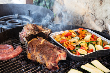 Barbaque outdoors with steak and vegetables