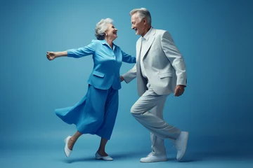 Deurstickers a elderly couple dancing happily and looking to each other in happiness © toonsteb
