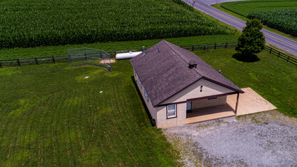 An Aerial View of an Amish One Room School House, in the Middle of a Corn Field, With a Baseball Field, on a Summer Day