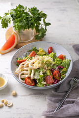 Thai Spicy Squid Salad in grey plate , Asian Food Concept. Low carb diet concept