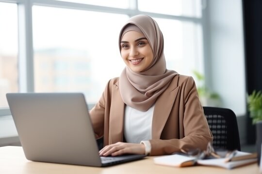 Happy Arabic business woman in hijab working in office