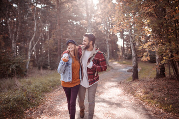 Young Caucasian couple hiking on a forest trail
