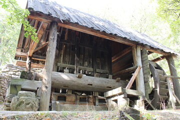 A log cabin with a broken down roof