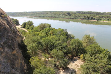 A river with trees and a hill