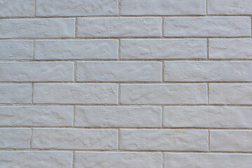 Horizontal cladding imitating brick painted white