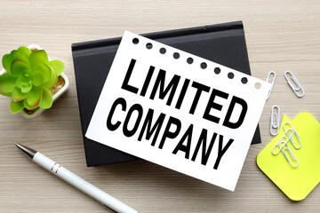 the words Limited company. on a white page on a black notepad