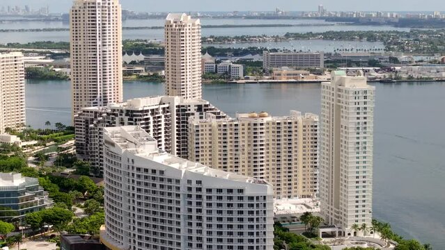 Aerial video condominiums on Brickel key Miami FL circa 2023 with view of port in background